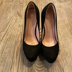 High-heeled, black suede shoes